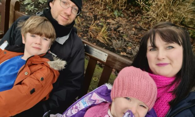Janine and Callum Norris with children Rory and Adara at their daughter Sylvie's bench.