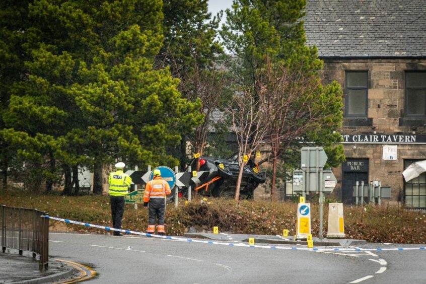 The car on its side on the Kirkcaldy roundabout after the crash.