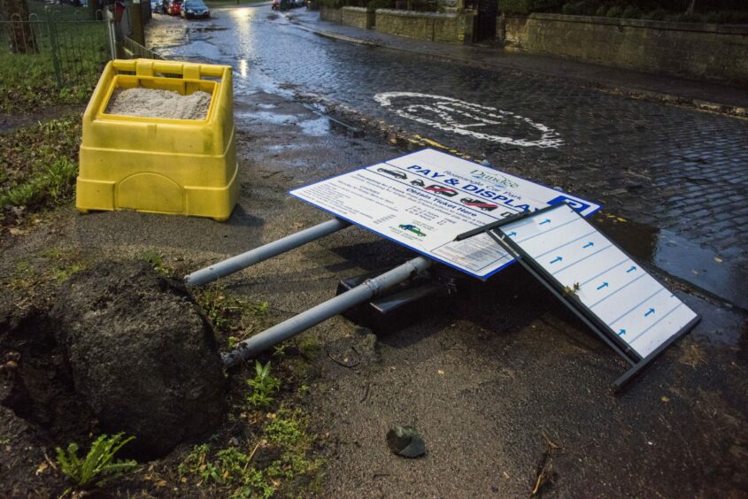 A sign at Roseangle carpark blown to the ground. Picture by Alan Richardson.