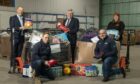 John Boumphrey, back left, Gordon Brown, centre and Paulinee Strachan, back right, with Amazon staff Simon McMahon, front left, Jamie Stain, bottom middle and Ben Robertson, bottom right, at the Lochgelly warehouse.