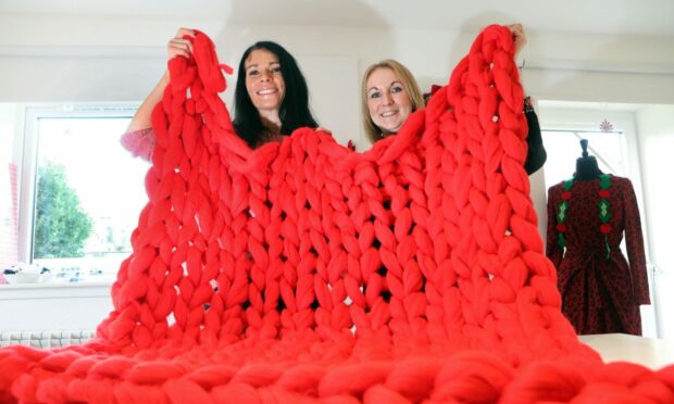Gayle Ritchie and Sandra Cassidy of Sew Confident with a chunky arm-blanket.
