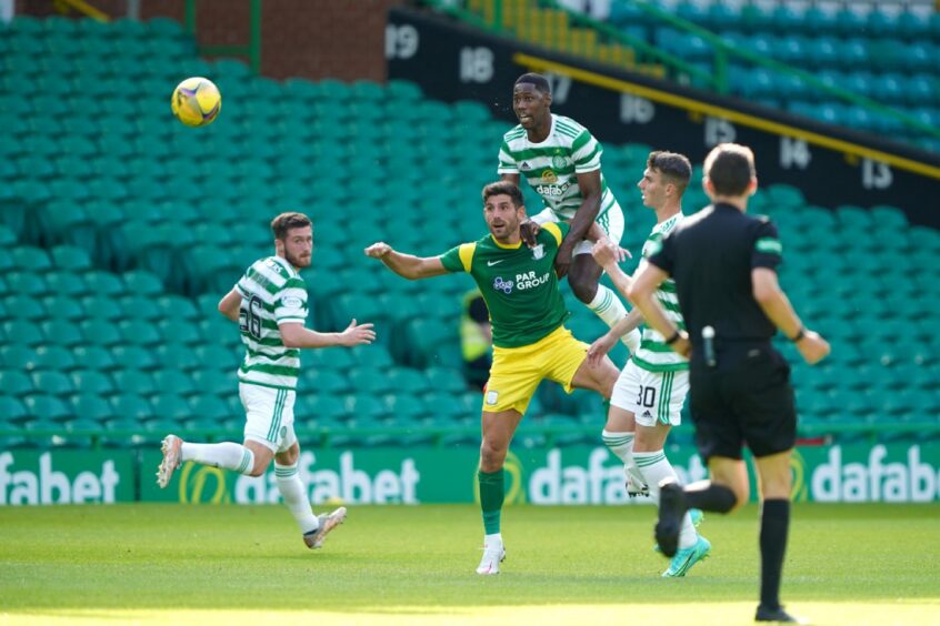 Celtic's Osaze Urhoghide and Preston North End's Ched Evans (front) battle for the ball during a pre-season friendly match at Celtic Park.