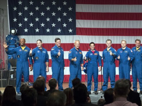 Astronauts, from left to right, Victor Glover, Michael Hopkins, Robert Behnken, Douglas Hurley, Nicole Mann, Christopher Ferguson, Eric Boe, Josh Cassada and Sunita Williams give a thumbs up to the crowd after Nasa announced them as astronauts assigned to crew the first flight tests and missions of the Boeing CST-100 Starliner and SpaceX Crew Dragon, (David J. Phillip/AP)