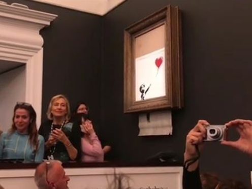 The moment when Girl With Balloon shredded itself after being sold for more than £1 million at a Sotheby’s auction (Banksy/PA)