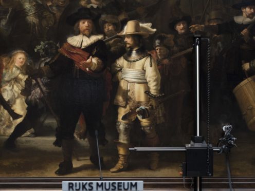 Equipement for analysing the painting’s condition is seen next to Rembrandt’s Night Watch (Peter Dejong/AP)