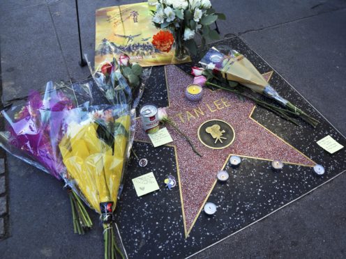 A wreath and other memorabilia adorn the star of Stan Lee on the Hollywood Walk of Fame, Monday, Nov. 12, 2018, in Los Angeles. Lee, the creative dynamo who revolutionized the comic book and helped make billions for Hollywood by introducing human frailties in superheroes such as Spider-Man, the Fantastic Four and the Incredible Hulk, died Monday. He was 95. (AP Photo/Reed Saxon)