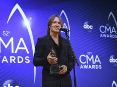 Keith Urban poses with the entertainer of the year award (Evan Agostini/Invision/AP)