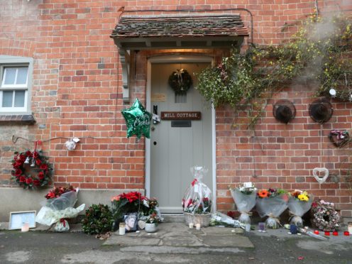 Floral tributes are left outside the home of George Michael in Goring-on-Thames, Oxfordshire (Steve Parsons/PA)