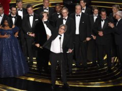 Peter Farrelly, centre, and the cast and crew of Green Book accept the award for best picture at the Oscars (Chris Pizzello/Invision/AP)