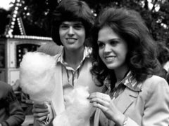 Marie Osmond with her brother Donny relaxing with candy floss in their younger days (PA)