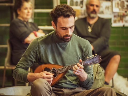 Alex Mugnaioni rehearses with the mandolin (Marc Brenner/PA)