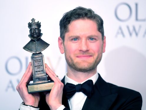 Kyle Soller with the Best actor award, in The Inheritance, presented by Sally Field and Bill Pullman at the Olivier Awards at the Royal Albert Hall in London. (Ian West/PA)