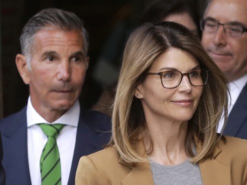 Actress Lori Loughlin, front, and husband, clothing designer Mossimo Giannulli, left, depart federal court in Boston (Steven Senne/AP)