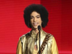FILE – In this Nov. 22, 2015, file photo, Prince presents the award for favorite album – Soul/R&B at the American Music Awards in Los Angeles. The memoir Prince was working on at the time of his death, “The Beautiful Ones,” is due out in late October 2019. (Photo by Matt Sayles/Invision/AP, File)
