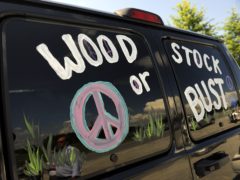 A van decorated with Woodstock or Bust at the original Woodstock Festival site in Bethel, New York (Stephen Chernin/AP)