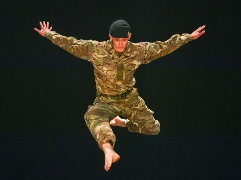 Trooper Alex Smith, of 1st The Queen’s Dragoon Guards, leaps into the air during rehearsals for 10 Soldiers (Ben Birchall/PA)