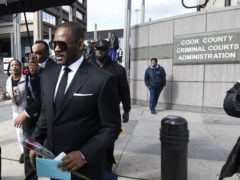 R Kelly leaves the Leighton Criminal Court building after a hearing in Chicago (Matt Marton/AP)