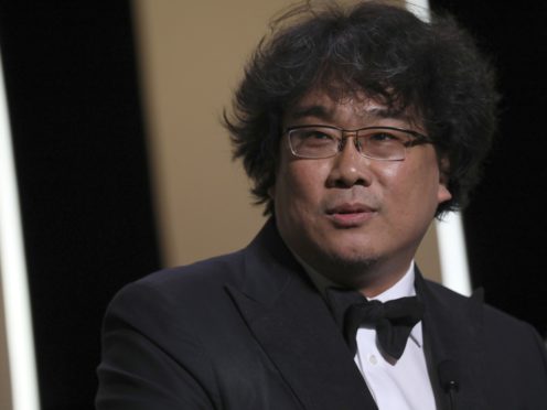 Director Bong Joon-ho poses with the Palme d’Or award for the film Parasite (Vianney Le Caer/AP)