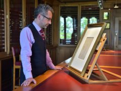 Martin Clayton, of the Royal Collection Trust, studies what he says is a sketch of Leonardo da Vinci (Royal Collection Trust/ Her Majesty Queen Elizabeth II 2019/PA)