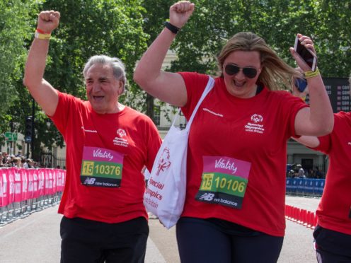 Jim Carter (left) runs a mile alongside disabled people for Special Olympics (Ken Hanrahan-Smith/PA)