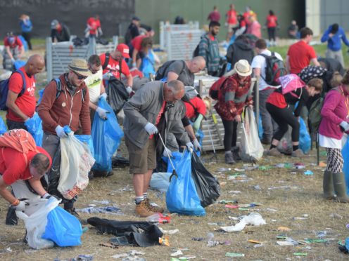Rubbish is collected following the Glastonbury Festival (Ben Birchall/PA)