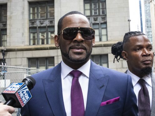 Musician R Kelly, centre, arriving for a court hearing (Ashlee Rezin/Chicago Sun-Times via AP)