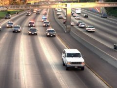 A white Ford Bronco, driven by Al Cowlings carrying OJ Simpson, is trailed by Los Angeles police cars as it travels on a road (JOseph R. Villarin/AP)