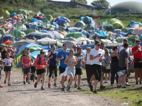 Glastonbury festival-goers going for a morning run (Yui Mok/PA)