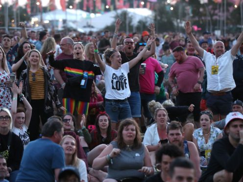 Festival-goers watch the England World Cup match on a big screen at Glastonbury Festival (Yui Mok/PA)