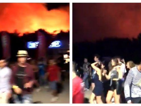 Festival-goers evacuate as the fire burns near the site (shh360/PA)
