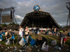 The clean-up begins in front of the Pyramid Stage (Aaron Chown/PA)