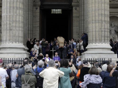 The coffin of French film director Jean-Pierre Mocky is carried down the steps of Saint Sulpice church in Paris (Lewis Joly/AP)