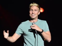 Russell Howard performing on stage at the Royal Albert Hall (PA)