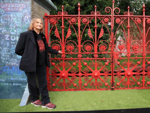 Julia Baird, John Lennon’s sister and honorary president of the Strawberry Field project, with the original Strawberry Field gates ahead of the opening of the former children’s home to the public (Peter Byrne/PA)