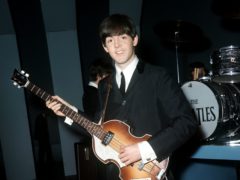 Sir Paul McCartney poses with one of his Hofner bass guitars (PA)