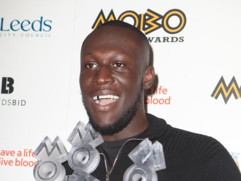 Stormzy with his best male, best album and best grime star awards at the 2017 Mobo Awards in Leeds (Danny Lawson/PA)