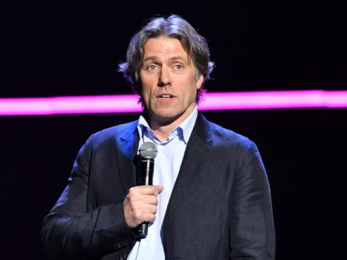 John Bishop said his wife had attempted to pull his piercing out several times (Matt Crossick/PA)