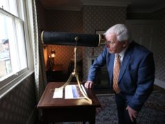 Sir David Attenborough looks through a telescope in what was JMW Turner’s bedroom (Jonathan Brady/PA)