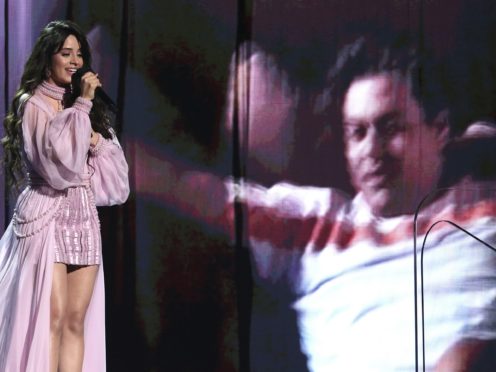 Camila Cabello performs First Man as an image of her dad Alejandro Cabello is projected on screen (Matt Sayles/AP/PA)