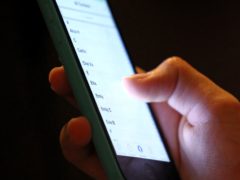 Half of UK adults take their mobile phone with them to the toilet, Direct Line Home Insurance found (Chris Radburn/PA)