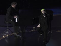 Finneas O’Connell and Billie Eilish perform during the In Memoriam section (AP/Chris Pizzello/PA)