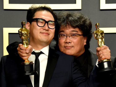 Han Jin-won and Bong Joon-ho with their Oscars for Best Original Screenplay, International Feature Film, Best Director, and Best Picture for Parasite in the press room at the 92nd Academy Awards (Jennifer Graylock/PA)