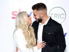 Love Island winners Paige Turley and Finley Tap share kiss at the Tric Awards (Ian West/PA)
