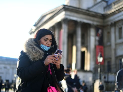 A woman wearing a face mask outside the National Gallery (Victoria Jones/PA)