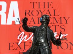 The statue of Sir Joshua Reynolds wearing a mask outside the Royal Academy of Arts in London (Kirsty O’Connor/PA)