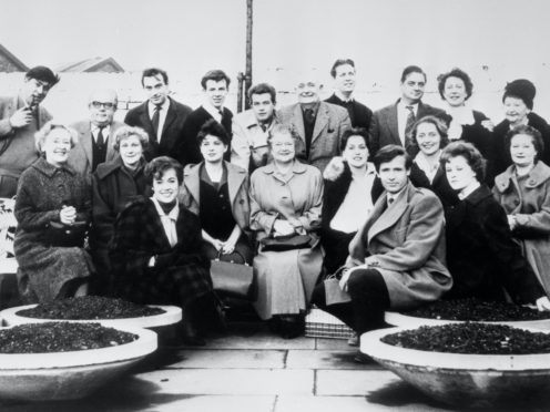 The cast of Coronation Street in the Granada TV Centre car park in Manchester, between rehearsals for the first programme broadcast on December 9 1960 (PA)