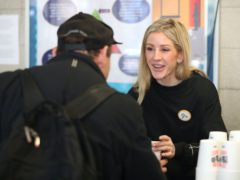 Ellie Goulding serves coffee to a guest while volunteering at a Crisis Christmas centre in London, as the charity opens its doors to homeless people for the festive period.