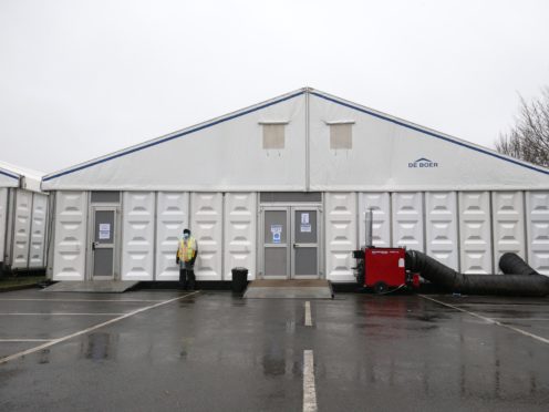 Security staff at the overflow mortuary at Breakspear Crematorium in Ruislip, London (Jonathan Brady/PA)