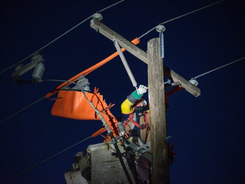 Power lines under repair in Texas (Odessa American/AP)