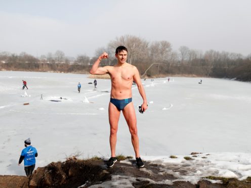 Freediver David Vencl reacts after setting a new world record in men’s swimming under ice near Teplice, Czech Republic, Tuesday, Feb. 23, 2021. Vencl swam the longest distance of 80.9 meters (265 ft) on Tuesday with breath held only in his swimsuit and swim goggles. In this category, freedivers cannot use any fin, diving suit, cap and weights. (AP Photo/Petr David Josek)